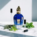 Decant de Xerjoff Torino21 en 3, 5 y 10 ml junto a la botella azul degradada original de Xerjoff con tomillo, verbena de limón y hojas de menta